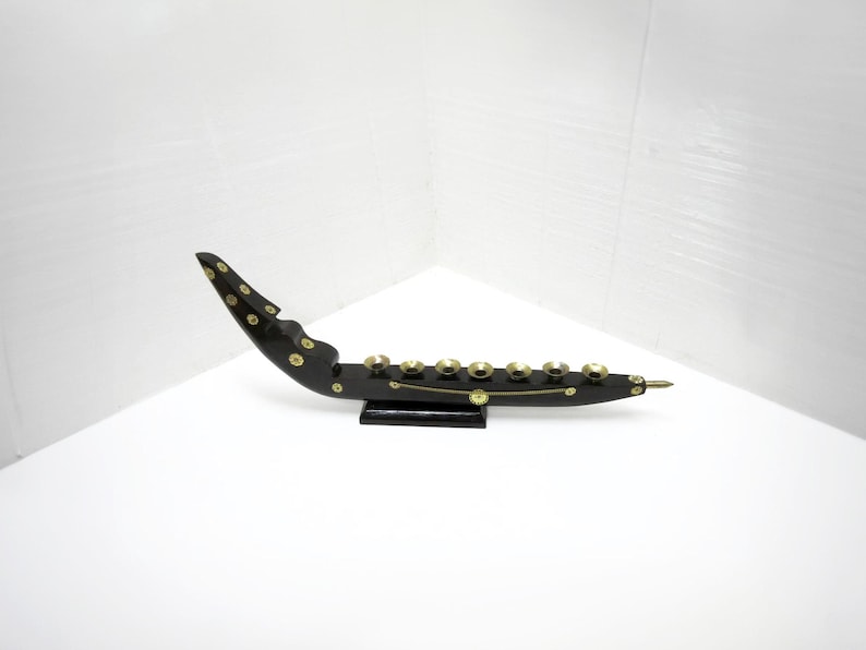 Wood and brass ship shaped seven candle holder